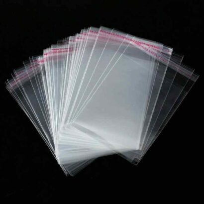 A stack of transparent OPP plastic bags with resealable adhesive strips, ideal for secure packaging and storage of various items.