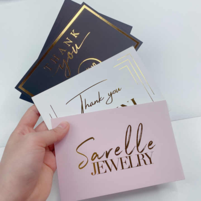 A selection of elegant foil business cards in various colors, featuring gold foil accents and personalized designs, perfect for branding and professional networking.