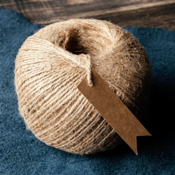 A durable and natural jute rope measuring 8mm in thickness, neatly coiled, ideal for packaging, crafts, and decorative purposes.