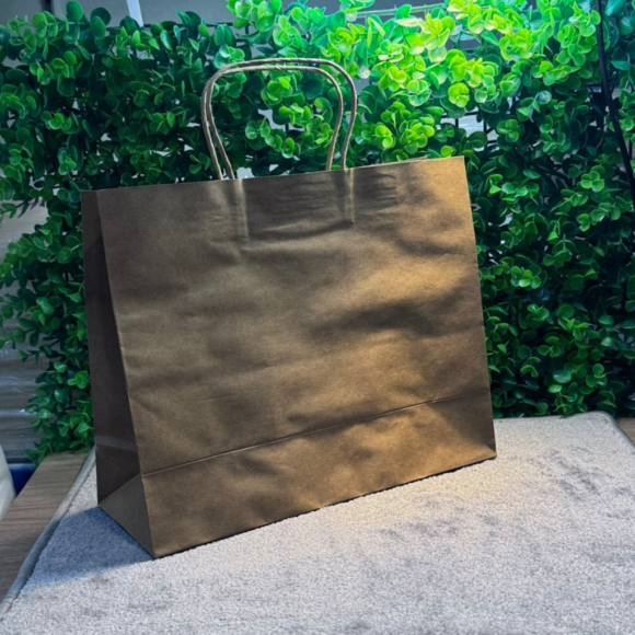 A collection of colorful A4-sized kraft paper bags with twisted handles, displayed on a gray background. Includes bags in white, pink, black, brown, and blue