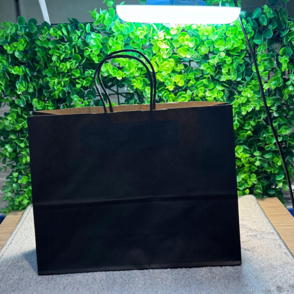 A collection of colorful A5-sized kraft paper bags with twisted handles, displayed on a gray background. Includes bags in white, pink, black, brown, and blue