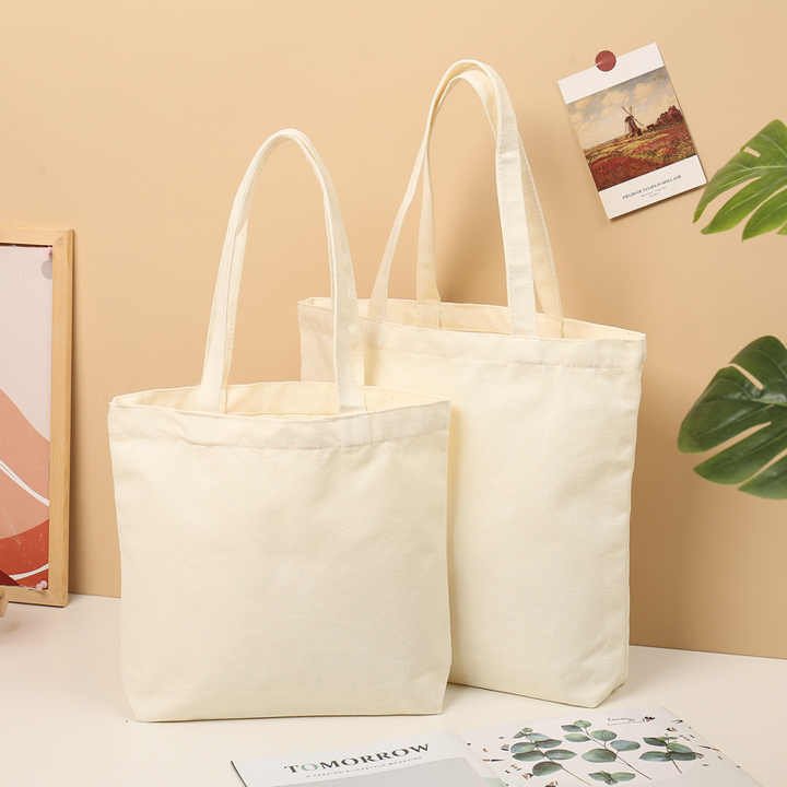 elegant plain cotton canvas tote bags in a natural beige color, featuring sturdy handles and a minimalist design. These eco-friendly bags are perfect for customization with printed logos, making them ideal for shopping or branding.